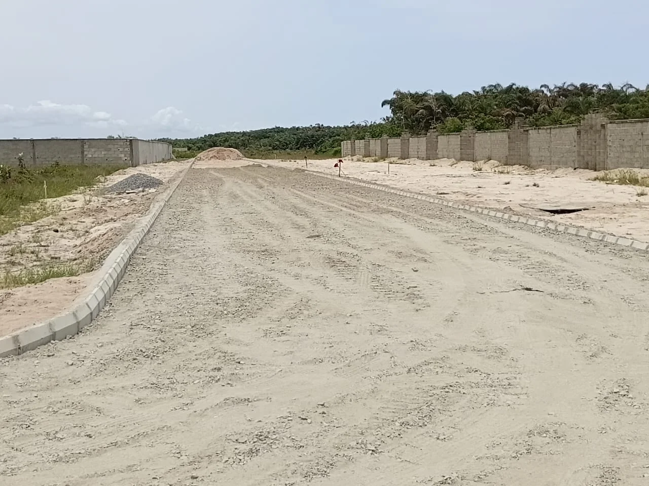 Road under construction with kerbs and prepared aggregate